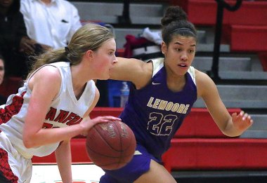 Lemoore's Aiyana Moore chases down Hanford's Kate McClard in the West Yosemite League season finale.